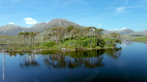 Aerial view of Twelve Pines Island, standing on a gorgeous background formed by the sharp peaks of a mountain range called Twelve Pins or Twelve Bens. Summer landscape. Connemara, Co. Galway, Ireland photo