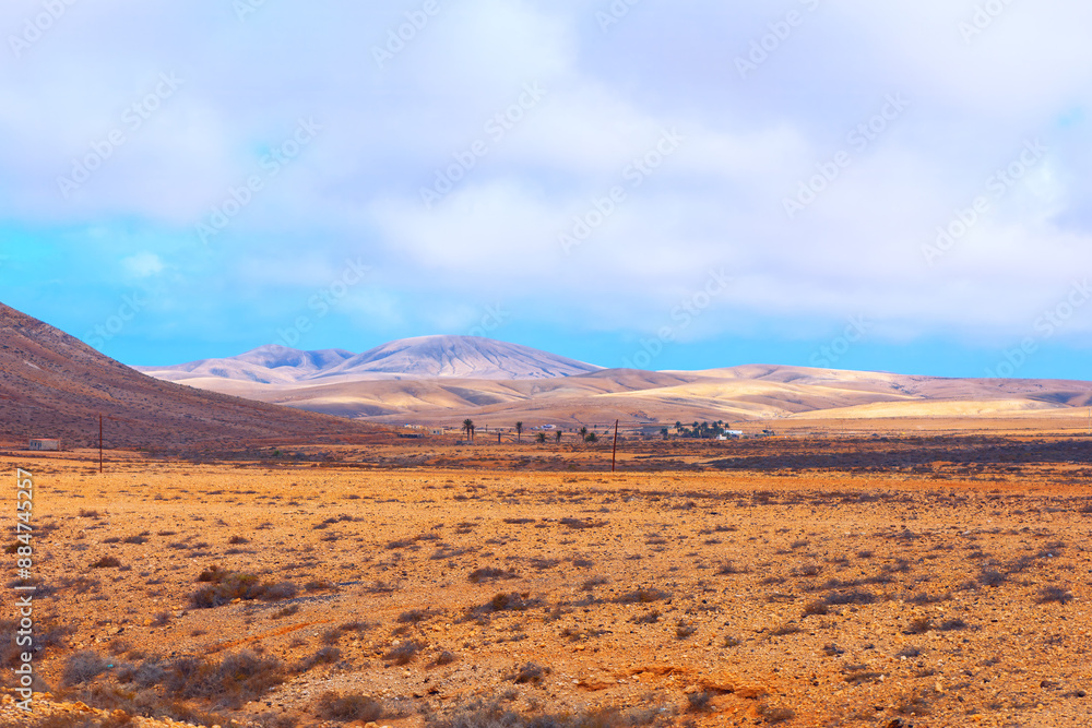 Desert landscape with mountains in the distance. Barren desert scenery of Fuerteventura, Canary Islands Desert landscape with mountains in the distance. Barren desert scenery of Fuerteventura, Canary Islands