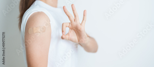 Foto Woman with bandage after receiving vaccine