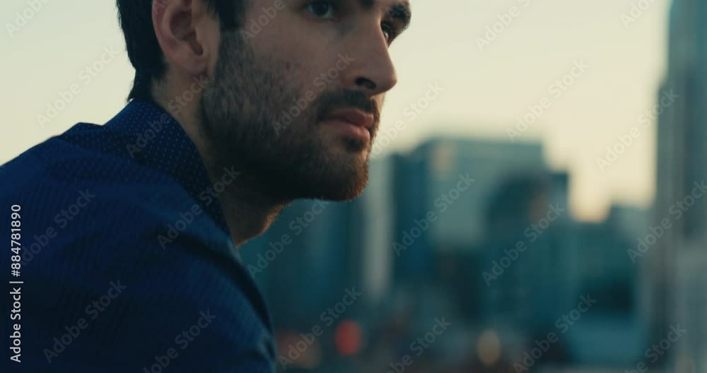 Young man standing on a bridge looking out at the sunset Young man standing on a bridge looking out at the sunset