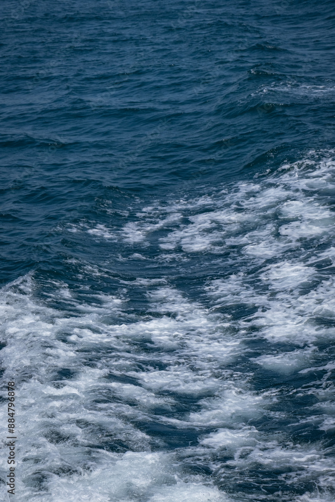 Waves and white foam on the sea as the ship sails Waves and white foam on the sea as the ship sails