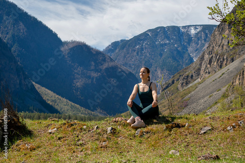 Woman meditating, zen yoga meditation practice in nature. Yogi girl is sitting in lotus pose, healthy lifestyle, meditation concept