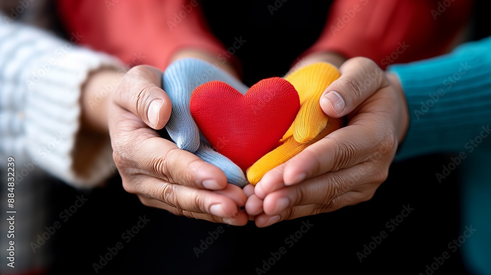 Multiple Hands in Different Colored Gloves Holding a Red Heart Together, Symbolizing Unity, Support, Friendship, and Love Multiple Hands in Different Colored Gloves Holding a Red Heart Together, Symbolizing Unity, Support, Friendship, and Love