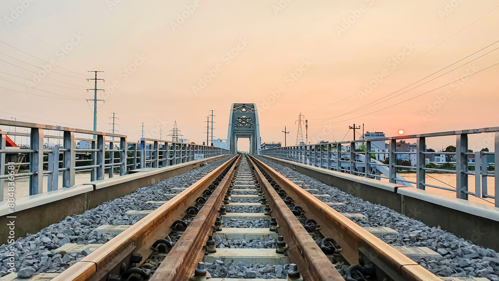 New Binh Loi Railway Bridge At Sunset In Ho Chi Minh City, Vietnam. New Binh Loi Railway Bridge Was Built To Replace The Old One, Which Has Been In Operation For 110 Years New Binh Loi Railway Bridge At Sunset In Ho Chi Minh City, Vietnam. New Binh Loi Railway Bridge Was Built To Replace The Old One, Which Has Been In Operation For 110 Years