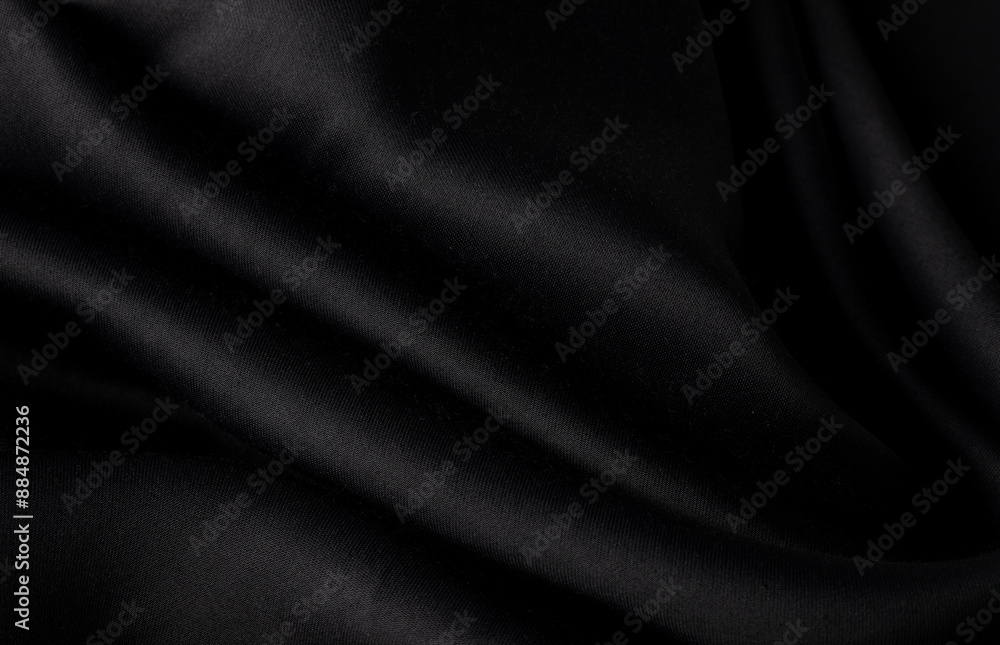 Obraz premium Black silk waves fabric texture, Luxury fabric textile for fashion cloth,