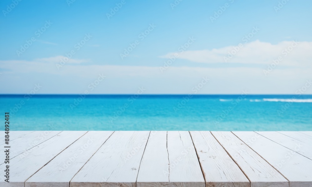 Fototapeta premium White wooden table against a blurred ocean background