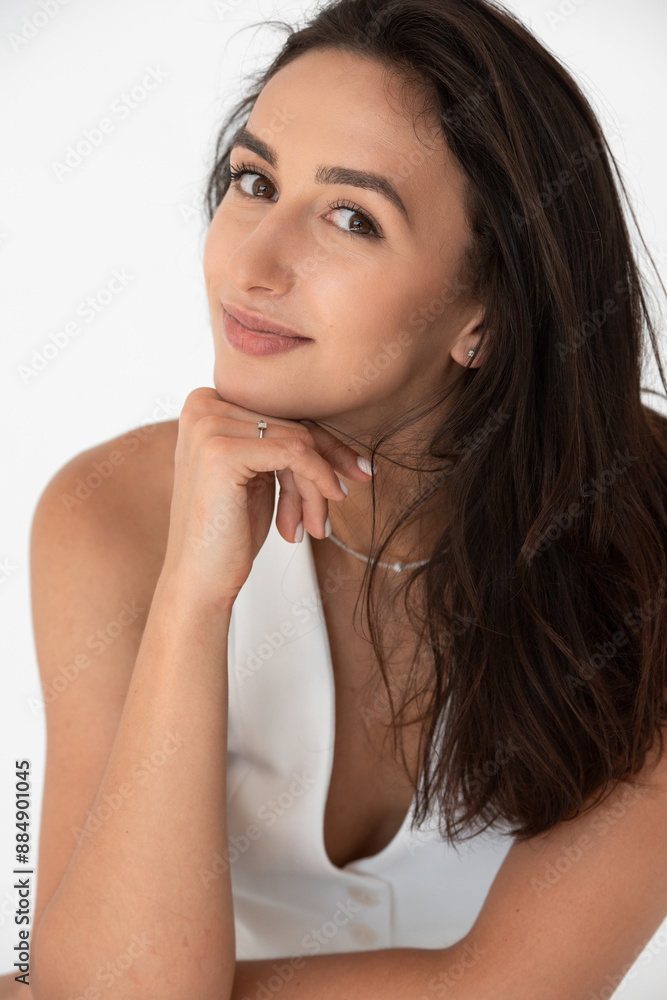 Happy beautiful girl posing in a new hot summer look. Wearing blue jeans and white waistcoat Happy beautiful girl posing in a new hot summer look. Wearing blue jeans and white waistcoat
