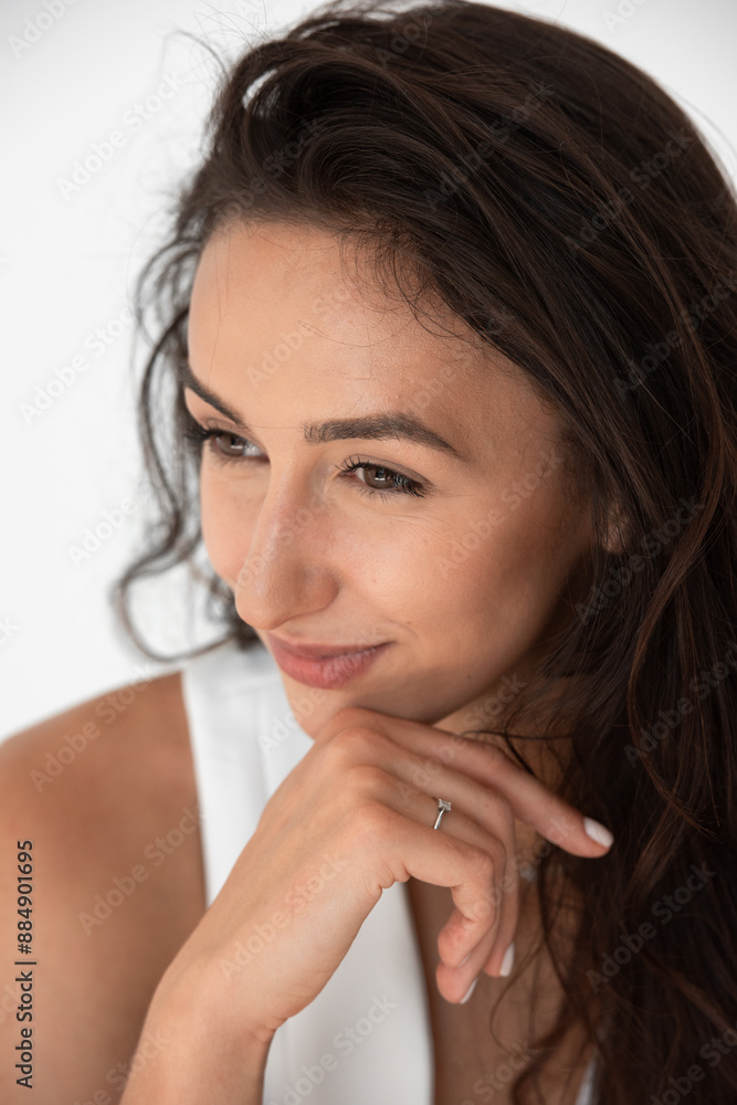 Happy beautiful girl posing in a new hot summer look. Wearing blue jeans and white waistcoat Happy beautiful girl posing in a new hot summer look. Wearing blue jeans and white waistcoat