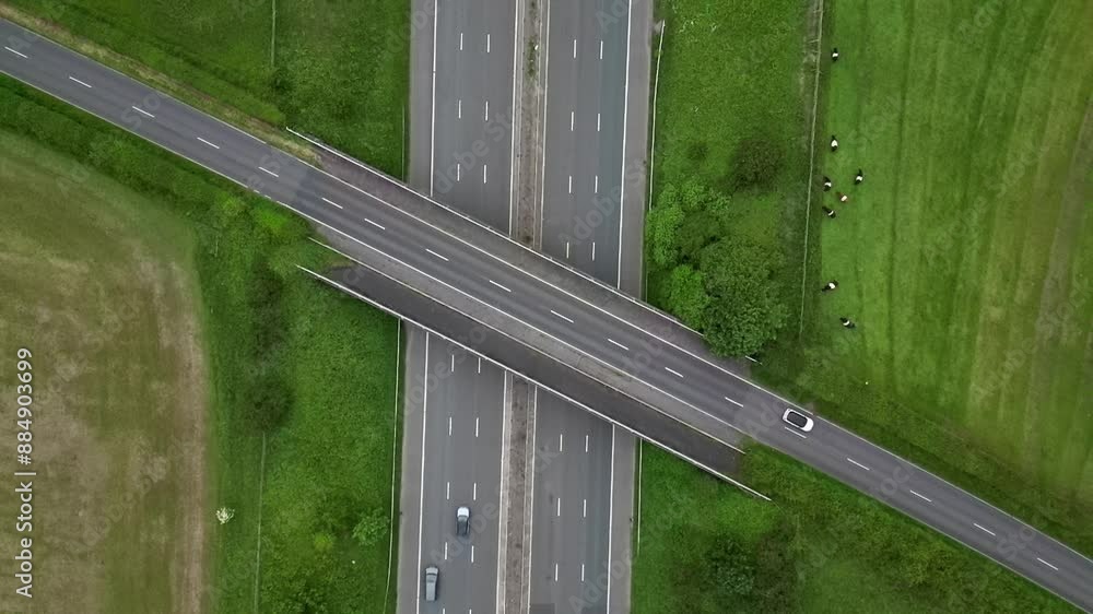 Busy motorway crossing. Drone shot of some cars passing Busy motorway crossing. Drone shot of some cars passing
