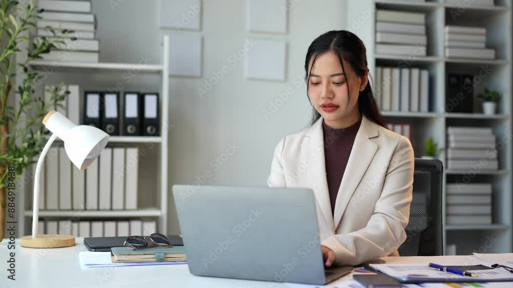 Asian businesswoman, self-employed working on laptop computer typing e-commerce marketing financial report on real estate project in office management concept. Asian businesswoman, self-employed working on laptop computer typing e-commerce marketing financial report on real estate project in office management concept.