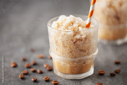 Frozen mocha coffee slushy in a glass on the table. Summer drink concept photo