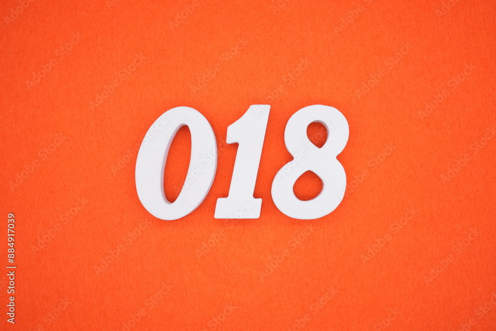 The numbers are made of white painted wood. Placed on the floor was orange paper. The numbers are made of white painted wood. Placed on the floor was orange paper.