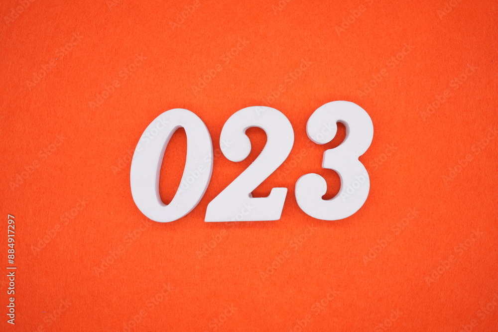 The numbers are made of white painted wood. Placed on the floor was orange paper. The numbers are made of white painted wood. Placed on the floor was orange paper.