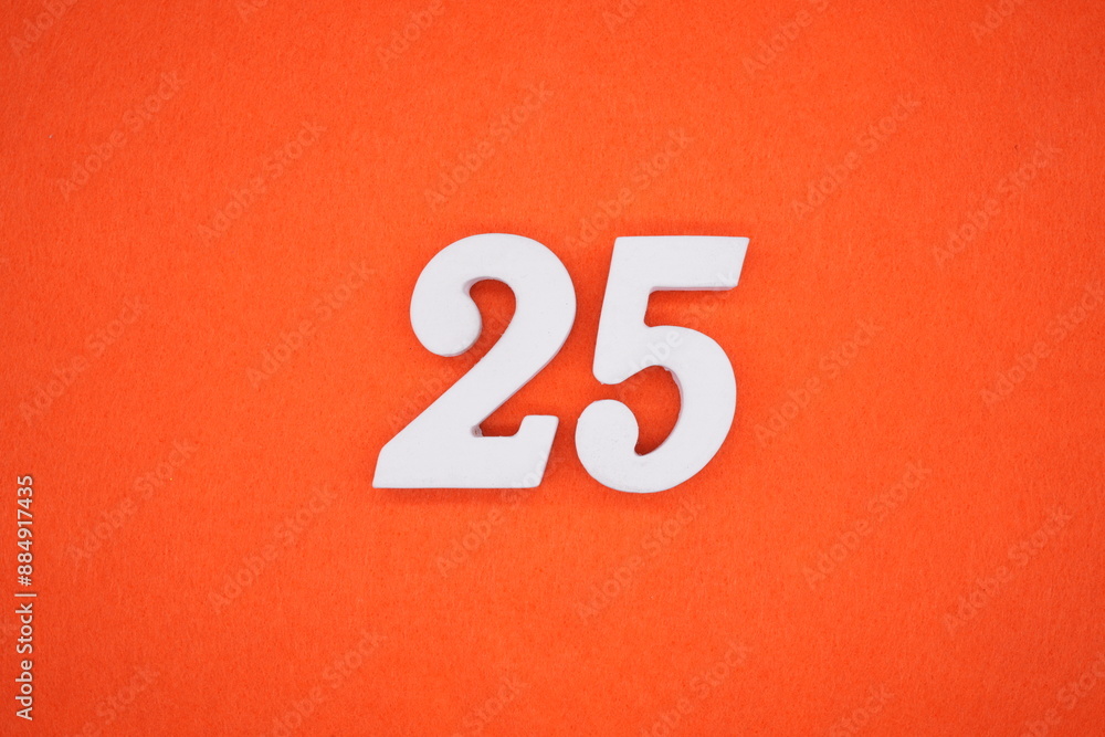 The numbers are made of white painted wood. Placed on the floor was orange paper. The numbers are made of white painted wood. Placed on the floor was orange paper.