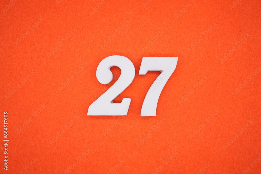 The numbers are made of white painted wood. Placed on the floor was orange paper. The numbers are made of white painted wood. Placed on the floor was orange paper.