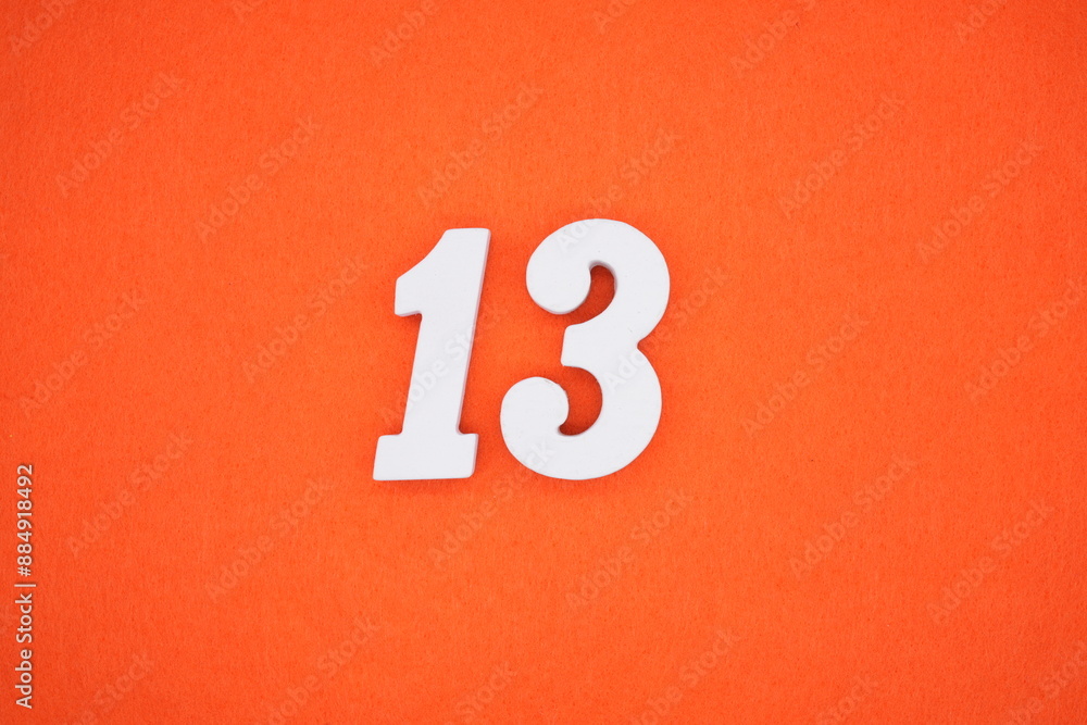 The numbers are made of white painted wood. Placed on the floor was orange paper. The numbers are made of white painted wood. Placed on the floor was orange paper.