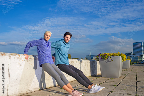 Two Positive Caucasian Runners Athletes Relaxing During Training Together And Smiling As Fitness Exercise Outside While Training photo