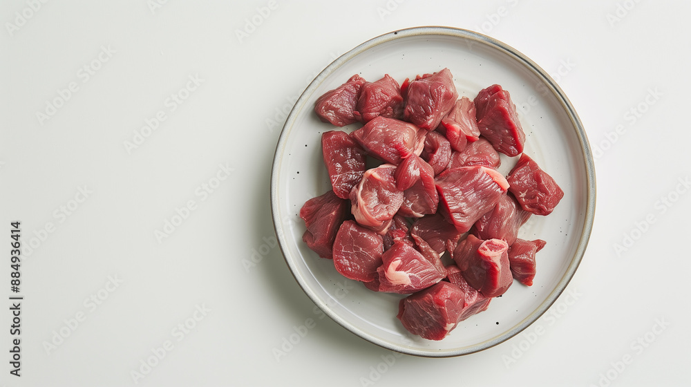 Meat slices, cut into small pieces on the white background Meat slices, cut into small pieces on the white background