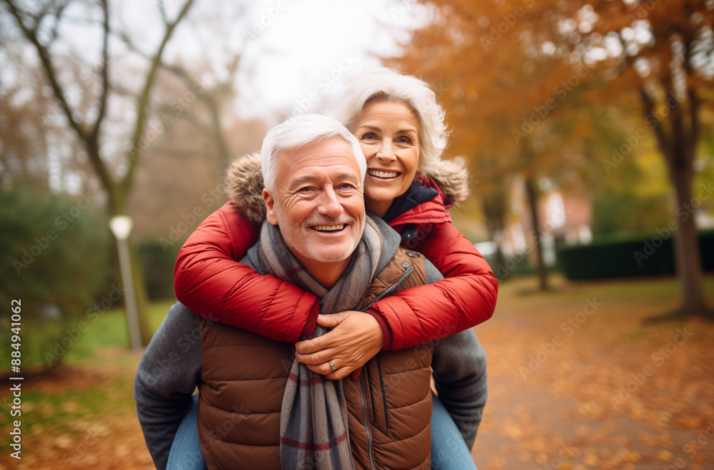 Senior Couple Enjoying Piggyback Ride And Laughing Together In Beautiful Autumn Park Senior Couple Enjoying Piggyback Ride And Laughing Together In Beautiful Autumn Park