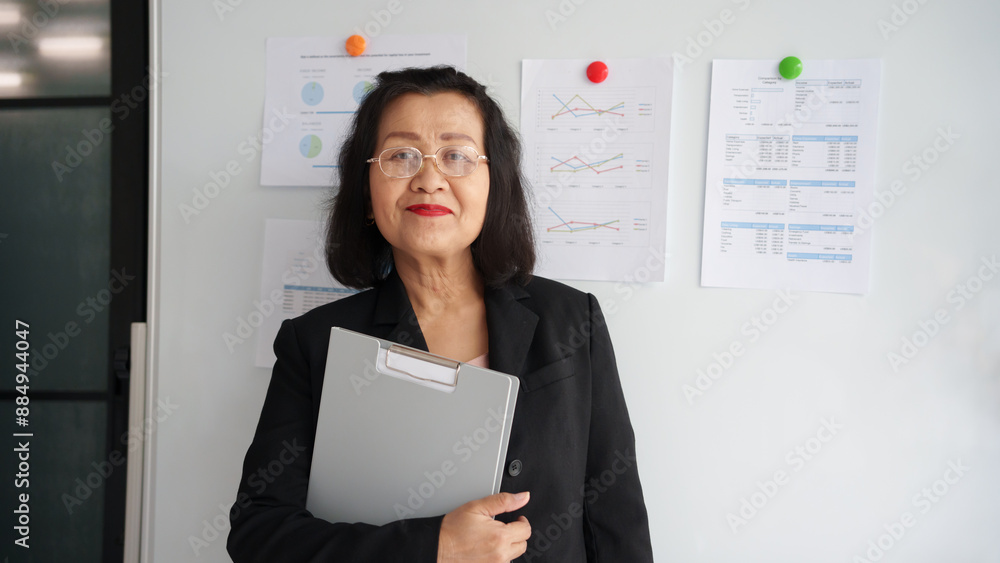 Older smiling 60s asian business woman.woman in office Older smiling 60s asian business woman.woman in office