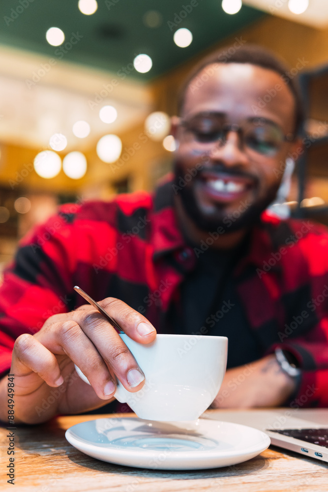 Smart american student is sitting at cafe while enjoying his cup of coffee. Smart american student is sitting at cafe while enjoying his cup of coffee.