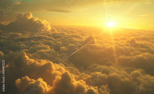 Golden sunrise over a sea of clouds with an airplane contrail. photo