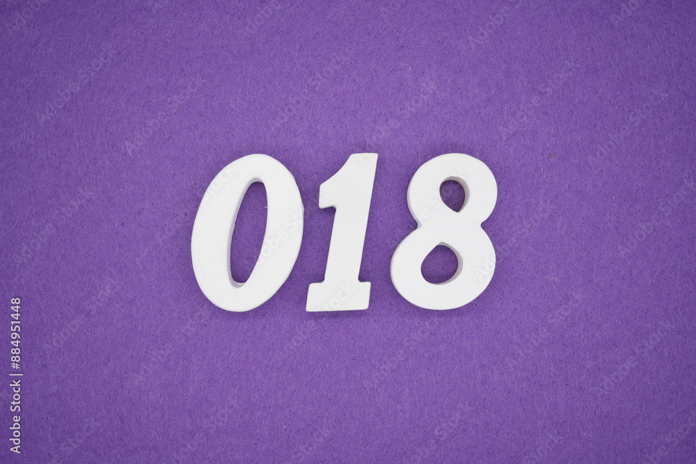 The numbers are made of white paint wood, placed on the background as a purple paper. The numbers are made of white paint wood, placed on the background as a purple paper.