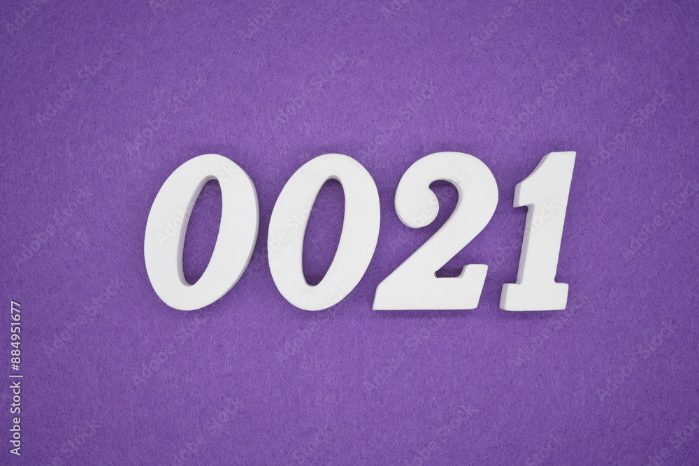 The numbers are made of white paint wood, placed on the background as a purple paper. The numbers are made of white paint wood, placed on the background as a purple paper.