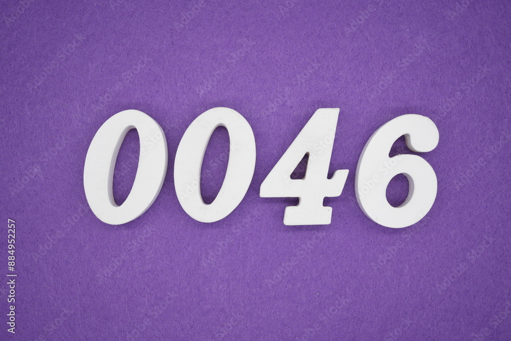 The numbers are made of white paint wood, placed on the background as a purple paper. The numbers are made of white paint wood, placed on the background as a purple paper.