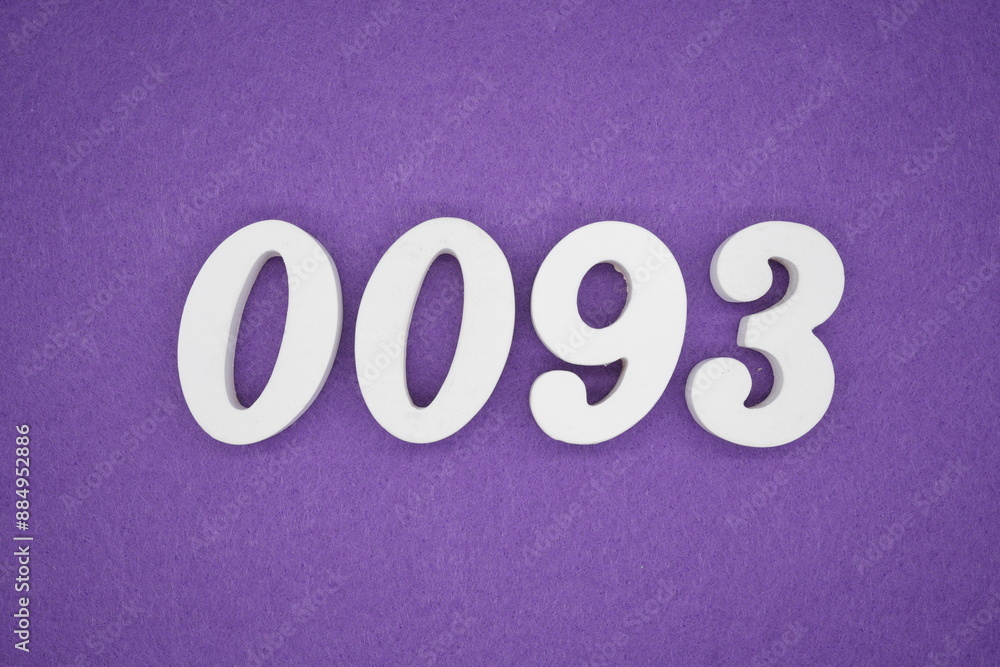 The numbers are made of white paint wood, placed on the background as a purple paper. The numbers are made of white paint wood, placed on the background as a purple paper.
