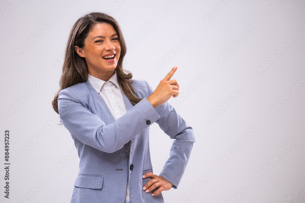 Portrait of cheerful businesswoman who is pointing at space for text or product. Portrait of cheerful businesswoman who is pointing at space for text or product.