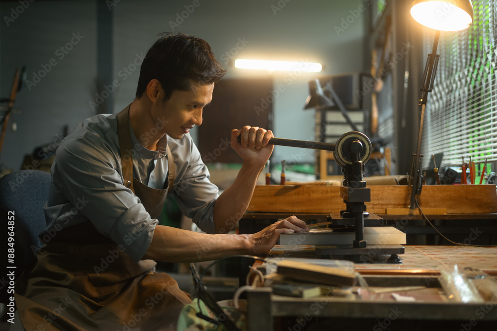 Leather craftsman creating product at his workbench. Small business and Leather craft process concept Leather craftsman creating product at his workbench. Small business and Leather craft process concept