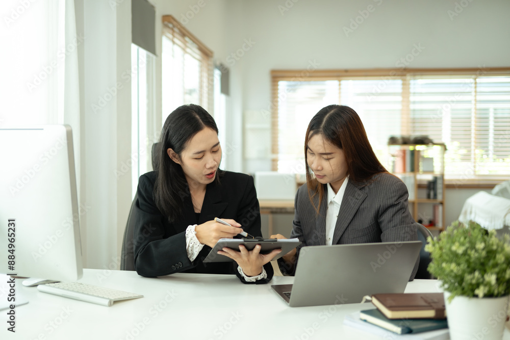 Businesswomen sharing ideas and discussing business strategy at modern office. Businesswomen sharing ideas and discussing business strategy at modern office.