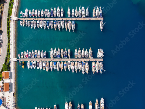 Scenic aerial view many yachts boats moored at Croatian bay harbor shore blue turquoise clear water at bright summer sunny day. Top above Mediterranean sea marina. Boat vessel charter service