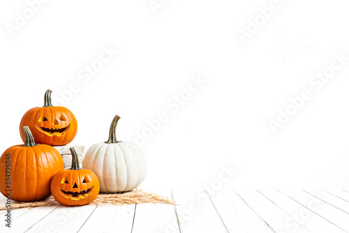 Jack-o'-lantern pumpkins on white wood background with copy space photo