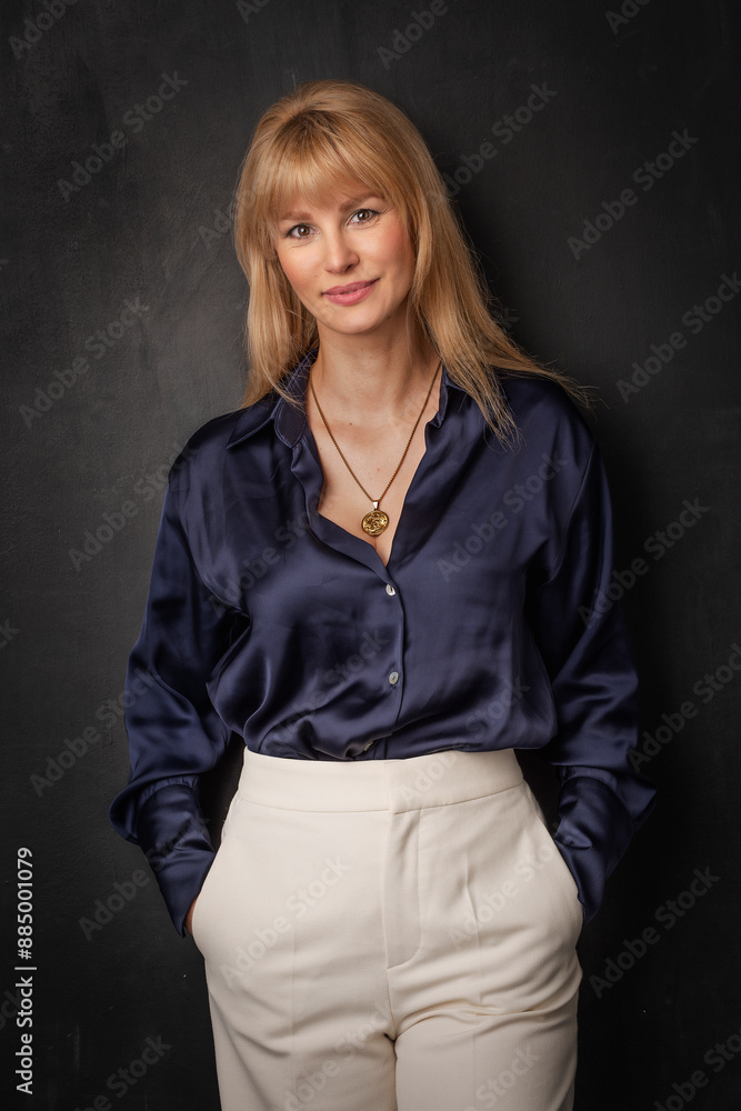 Studio portrait of a blond haired woman standing against isolated background Studio portrait of a blond haired woman standing against isolated background