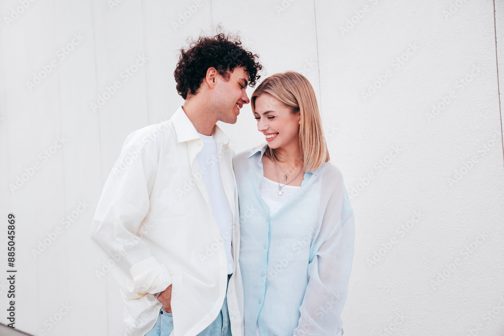 Smiling beautiful woman and her handsome boyfriend. Couple in casual summer clothes. Happy cheerful family. Female and man having fun. They posing in the street in sunny day. Having tender moments Smiling beautiful woman and her handsome boyfriend. Couple in casual summer clothes. Happy cheerful family. Female and man having fun. They posing in the street in sunny day. Having tender moments