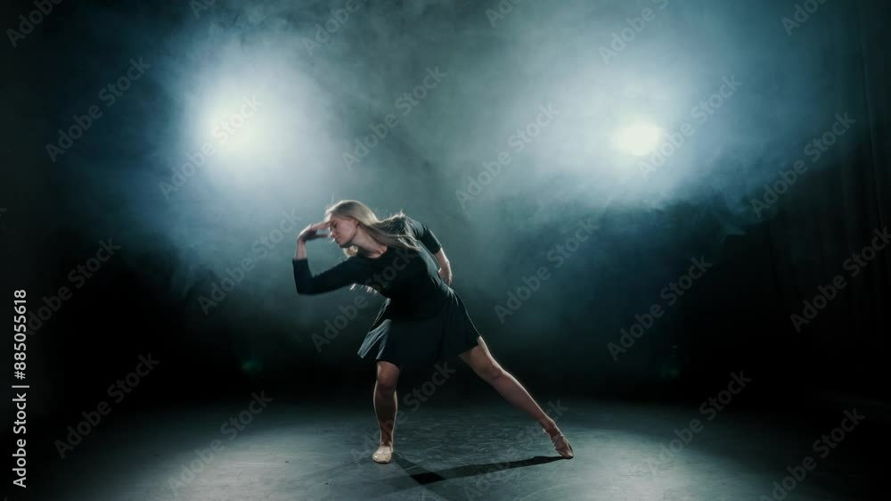 Fascinating dance performance of beautiful blonde woman in studio with smoke. Attractive young adult female dancers moving gracefully in darkness, mysterious lady, professional actress or ballerina Fascinating dance performance of beautiful blonde woman in studio with smoke. Attractive young adult female dancers moving gracefully in darkness, mysterious lady, professional actress or ballerina