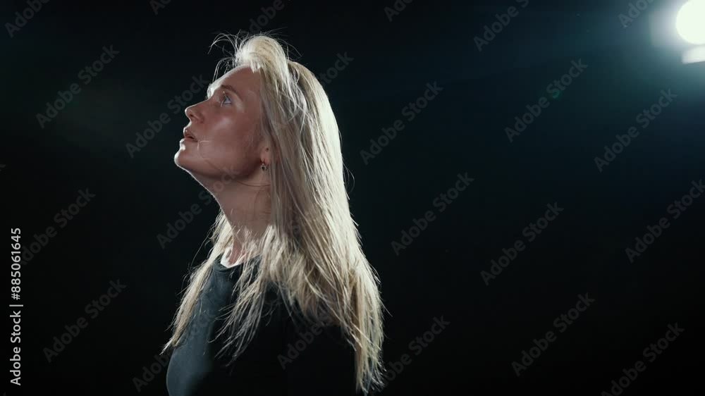Sensual and emotional dance of beautiful graceful young woman in dark studio. Blonde lady performing modern choreography, moving slowly in black background, talented pretty actress or female dancer Sensual and emotional dance of beautiful graceful young woman in dark studio. Blonde lady performing modern choreography, moving slowly in black background, talented pretty actress or female dancer