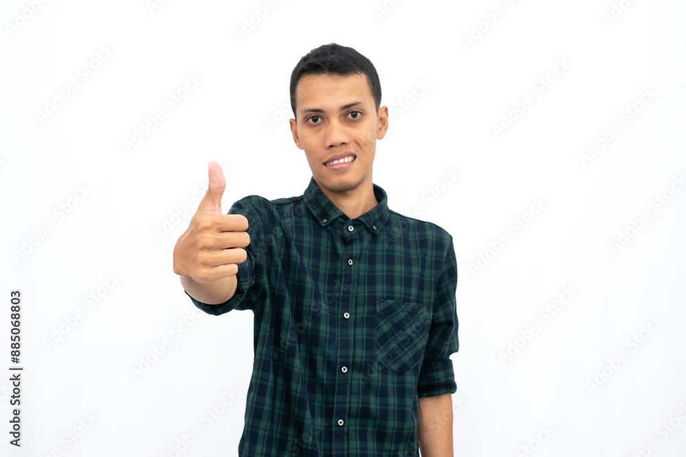 Asian man wearing a green checkered casual shirt stressed showing thumbs up that agree, okay, top. Isolated white background. Asian man wearing a green checkered casual shirt stressed showing thumbs up that agree, okay, top. Isolated white background.