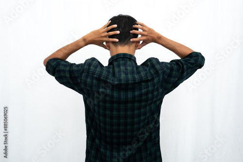 Back view of a man grabbing his head showing stress gesture photo