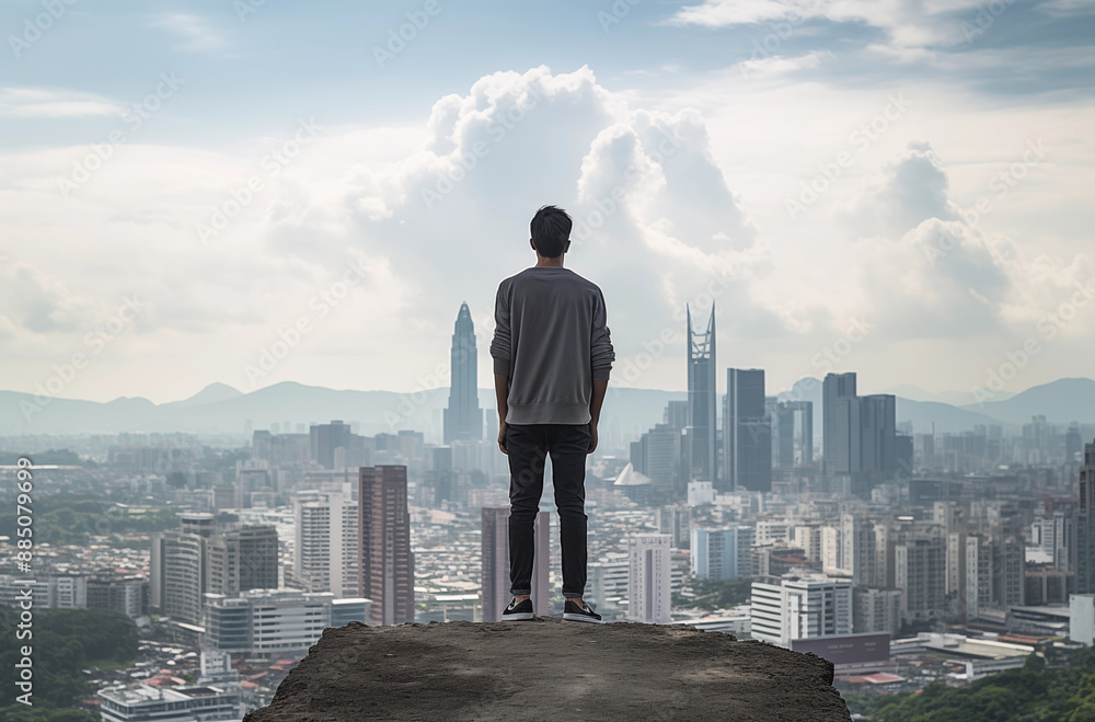 Man Standing on a Rooftop Overlooking a Modern City Skyline with Skyscrapers and a Cloudy Sky