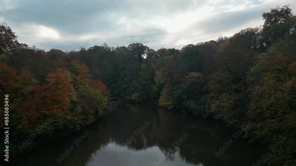 Drone flies low and slow over River Wear in Durham at the height of Autumn. Shot on overcast day Drone flies low and slow over River Wear in Durham at the height of Autumn. Shot on overcast day