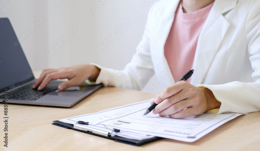 Fototapeta premium Business woman employer holding resume hiring recruit looking cv resume to hire candidates, analyzing information before job interview. Recruitment concepts