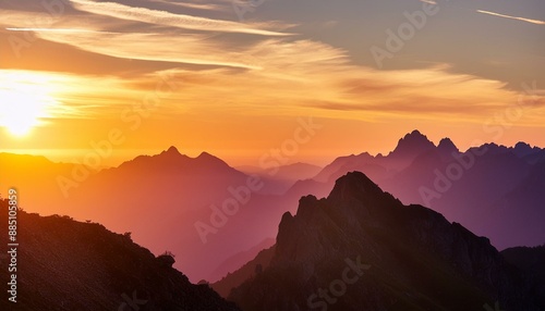 Mountains' silhouettes against a stunning sunset sky provide a captivating copy space image. 