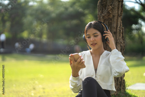 Portrait of smiling happy asian woman relax using digital smartphone.Young asian girl working or study,chatting social network and playing game online or social media,shopping online at city