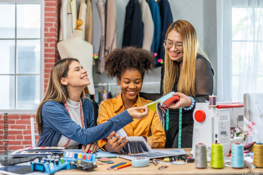 Fototapeta premium Collaboration and creativity in fashion design of teamwork, three diverse and talented designer collaborating on fabric swatches and design choices, creative studio, textile industry, fabric selection