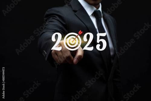 Businessman touching virtual screen with business plan or marketing strategy for the new year 2025 concept.