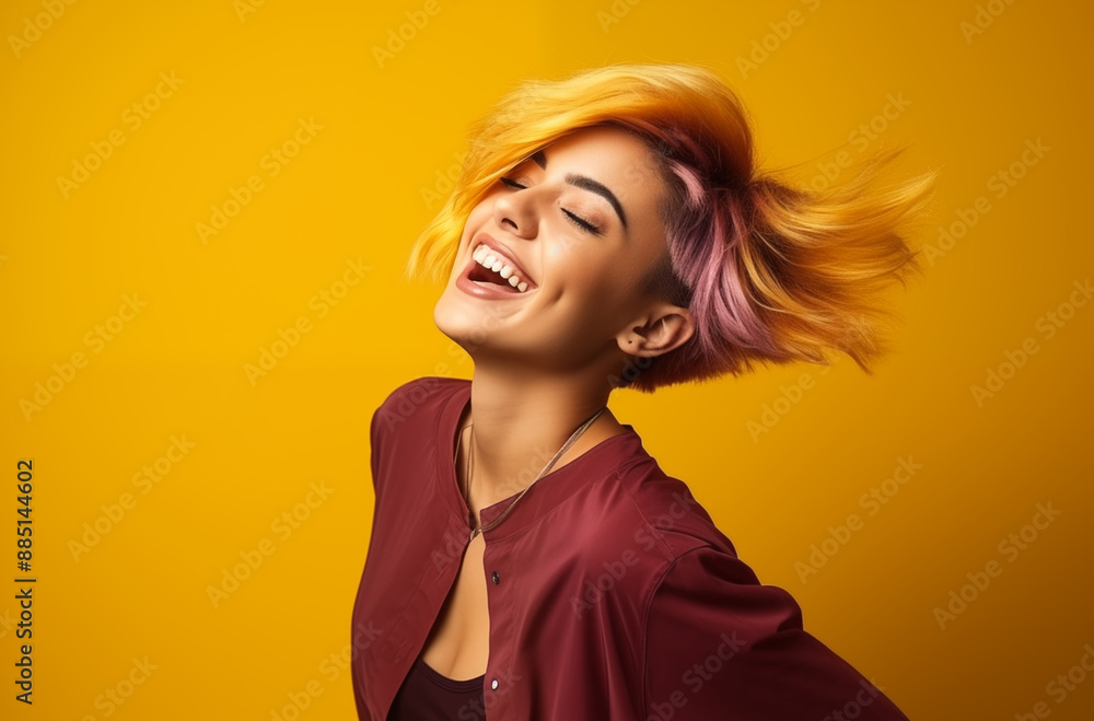 Happy Young Woman with Vibrant Multicolored Hair Smiling and Posing Against a Bright Yellow Background Happy Young Woman with Vibrant Multicolored Hair Smiling and Posing Against a Bright Yellow Background
