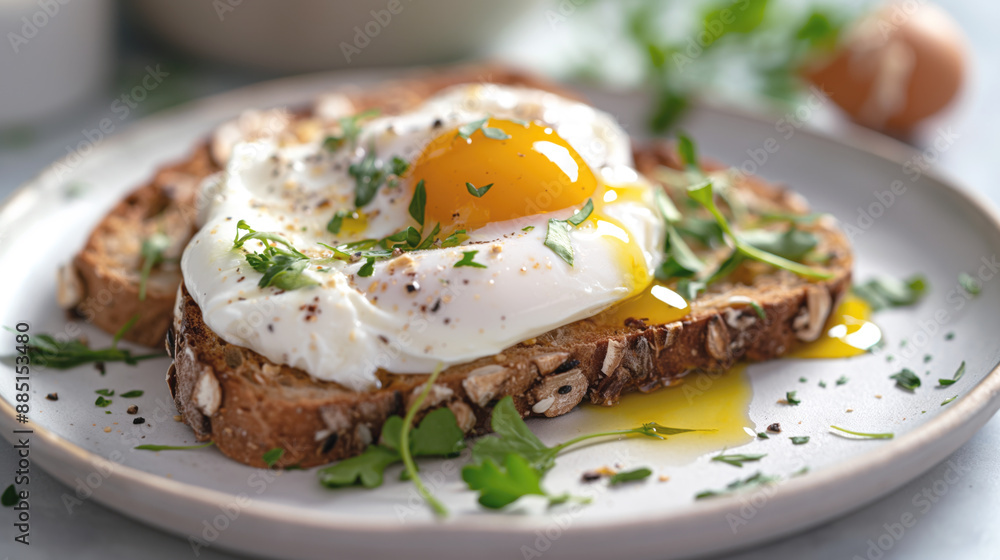 Close-up of a poached egg served on whole-grain toast, garnished with fresh herbs and black pepper, with runny yolk and greens around the plate. Close-up of a poached egg served on whole-grain toast, garnished with fresh herbs and black pepper, with runny yolk and greens around the plate.